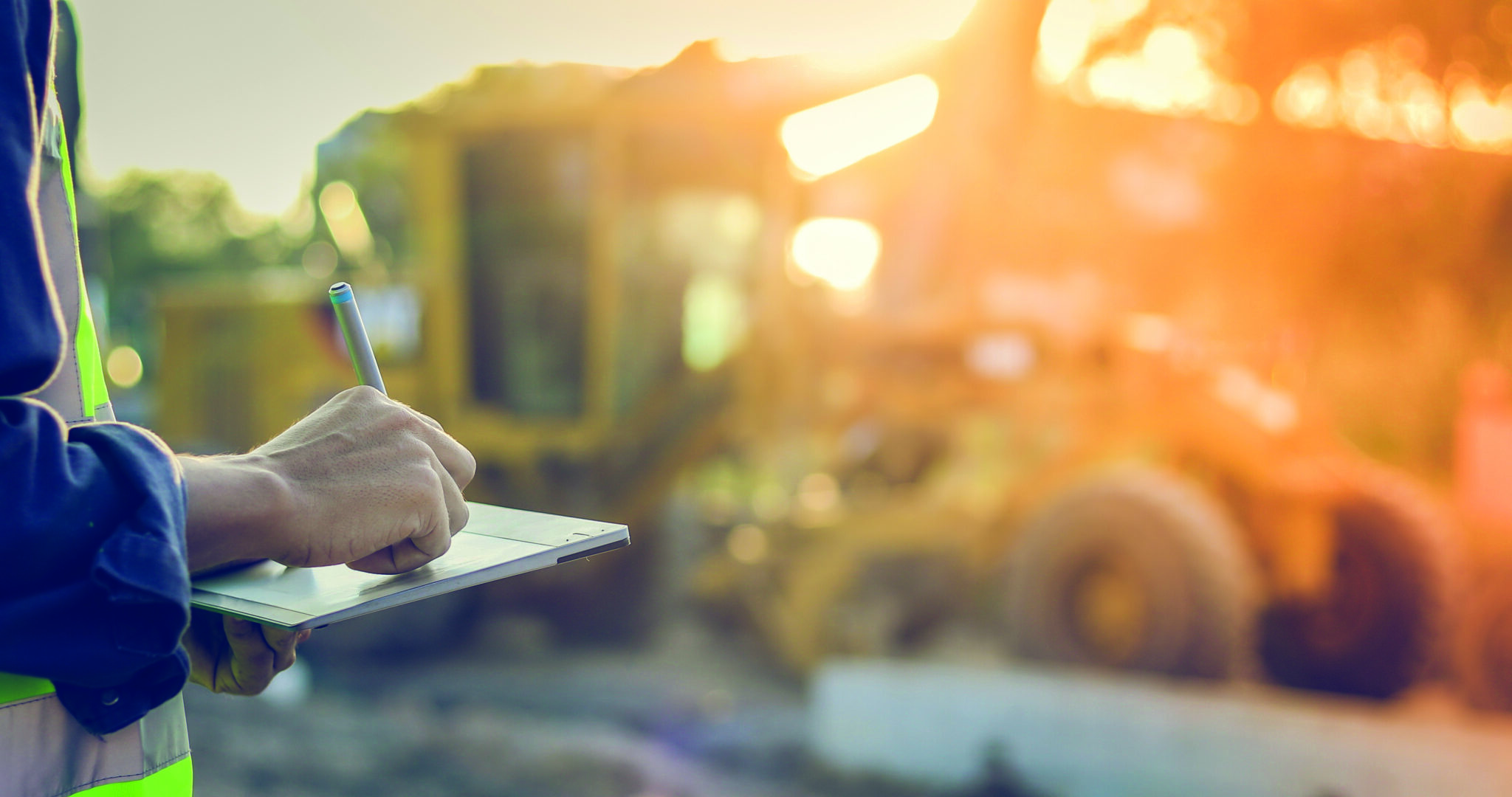engineer with hardhat using tablet pc computer inspecting