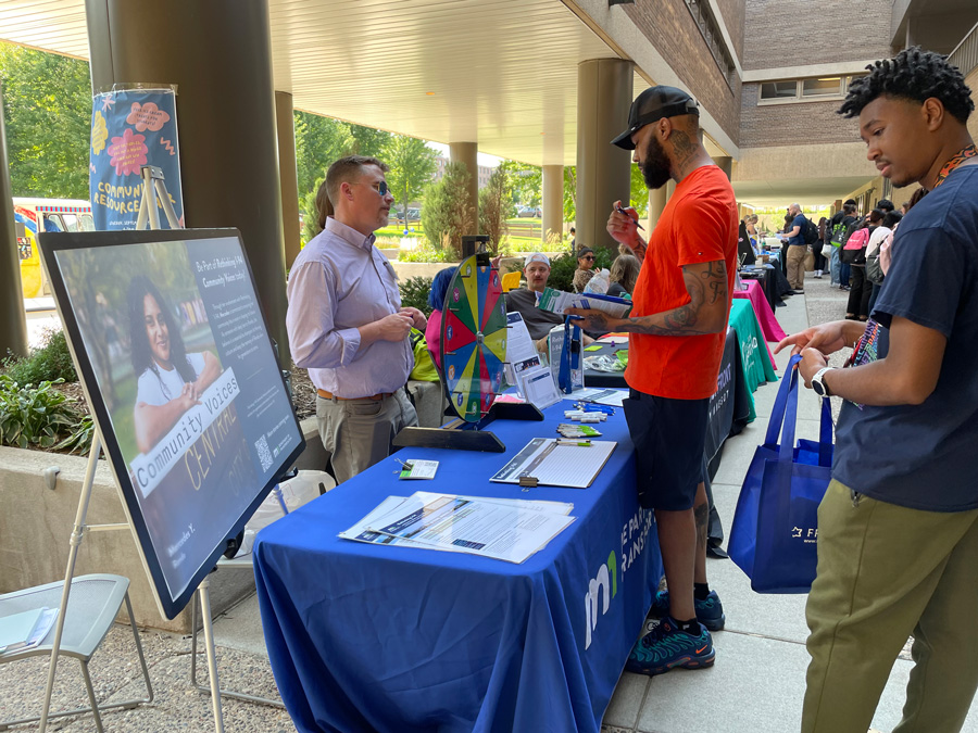 Group of people at an information booth