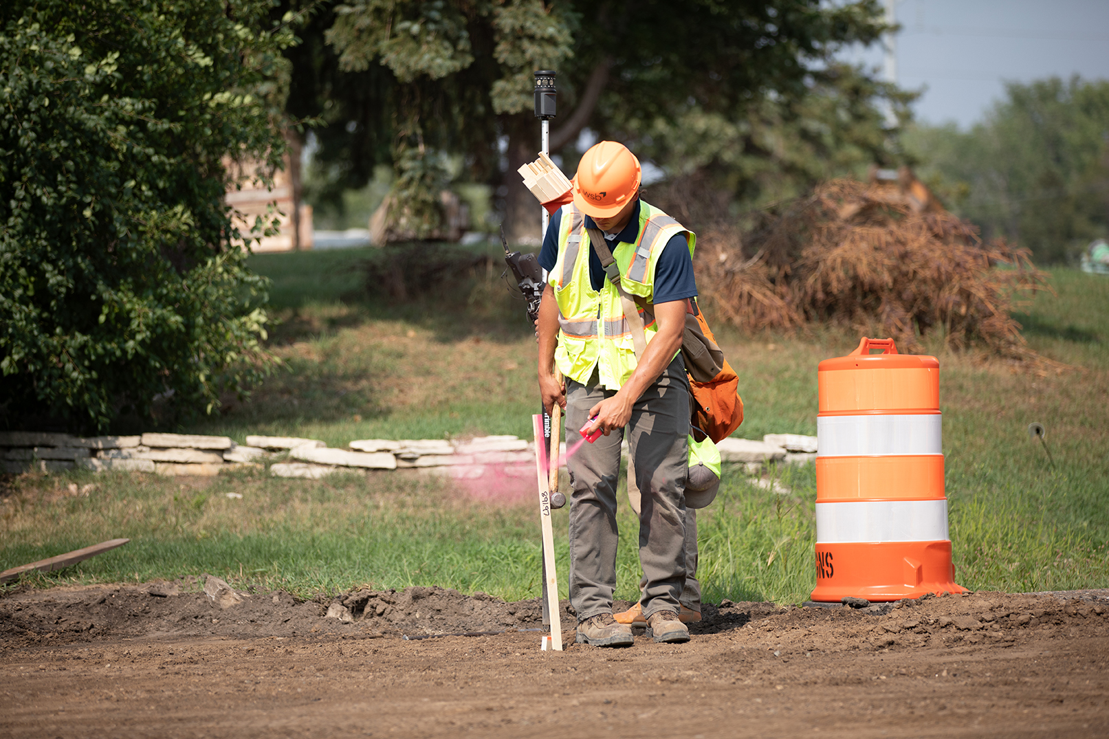 Construction worker putting stake in the ground