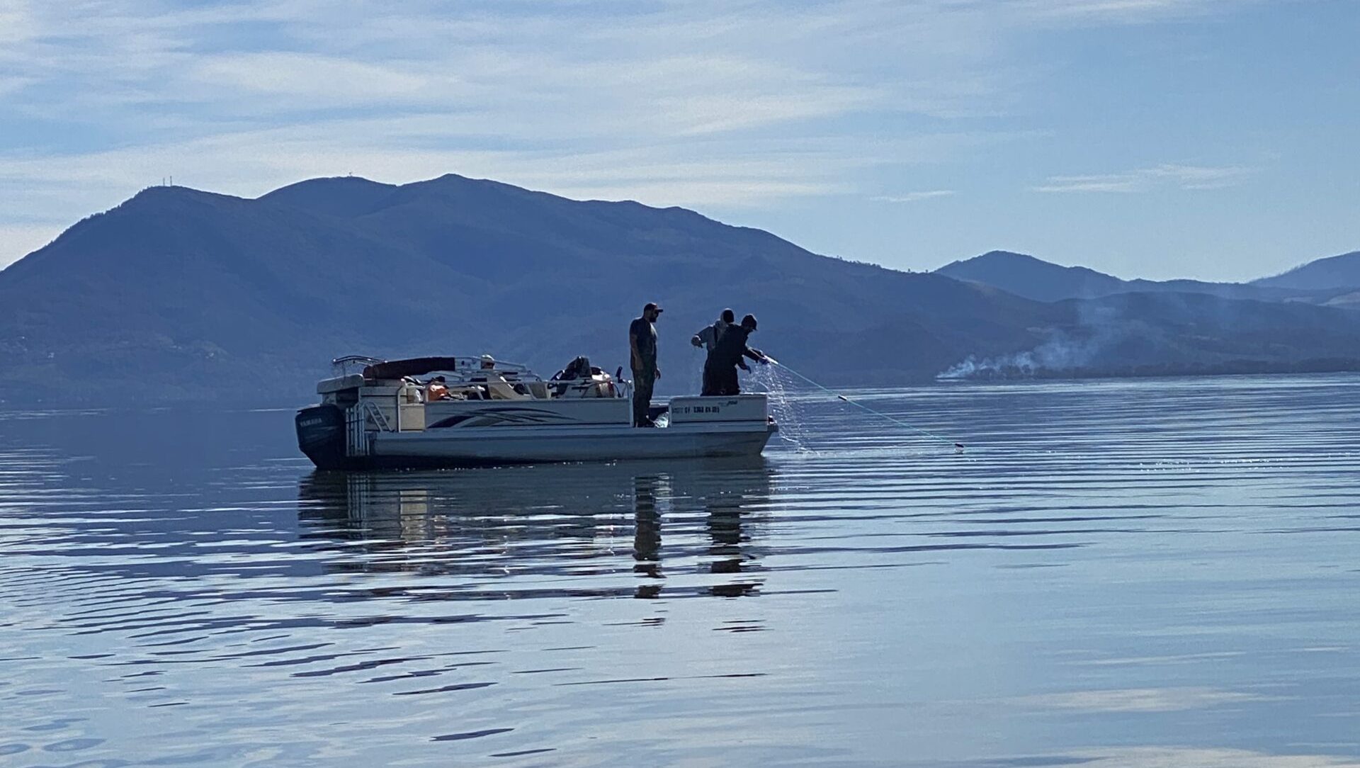 Fishing boat on clear lake in california