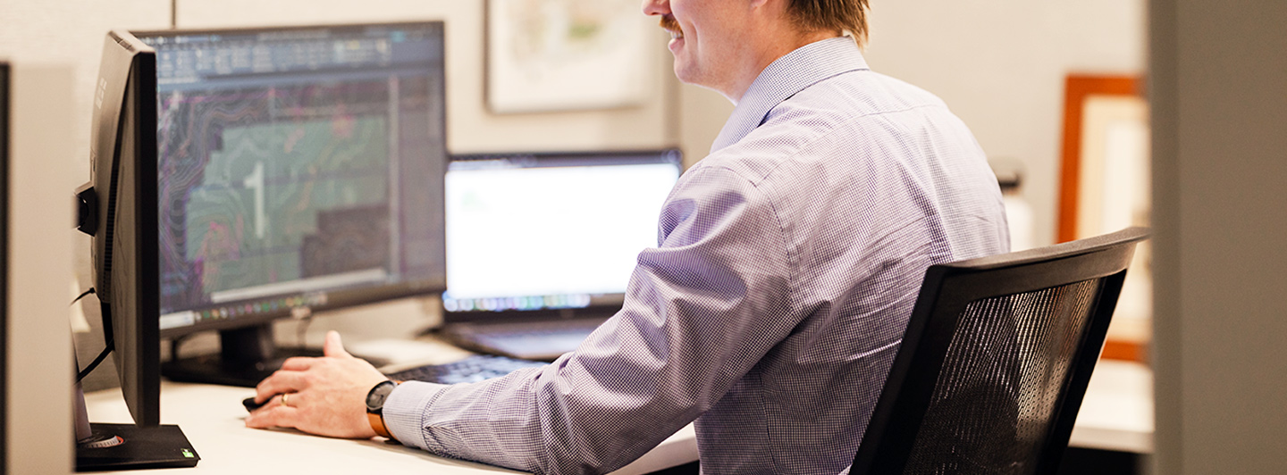 Person working on a computer at a desk