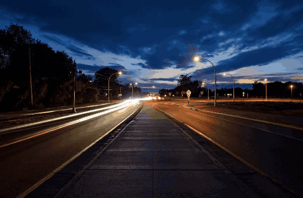 Moving image of a cars driving through a roundabout at night