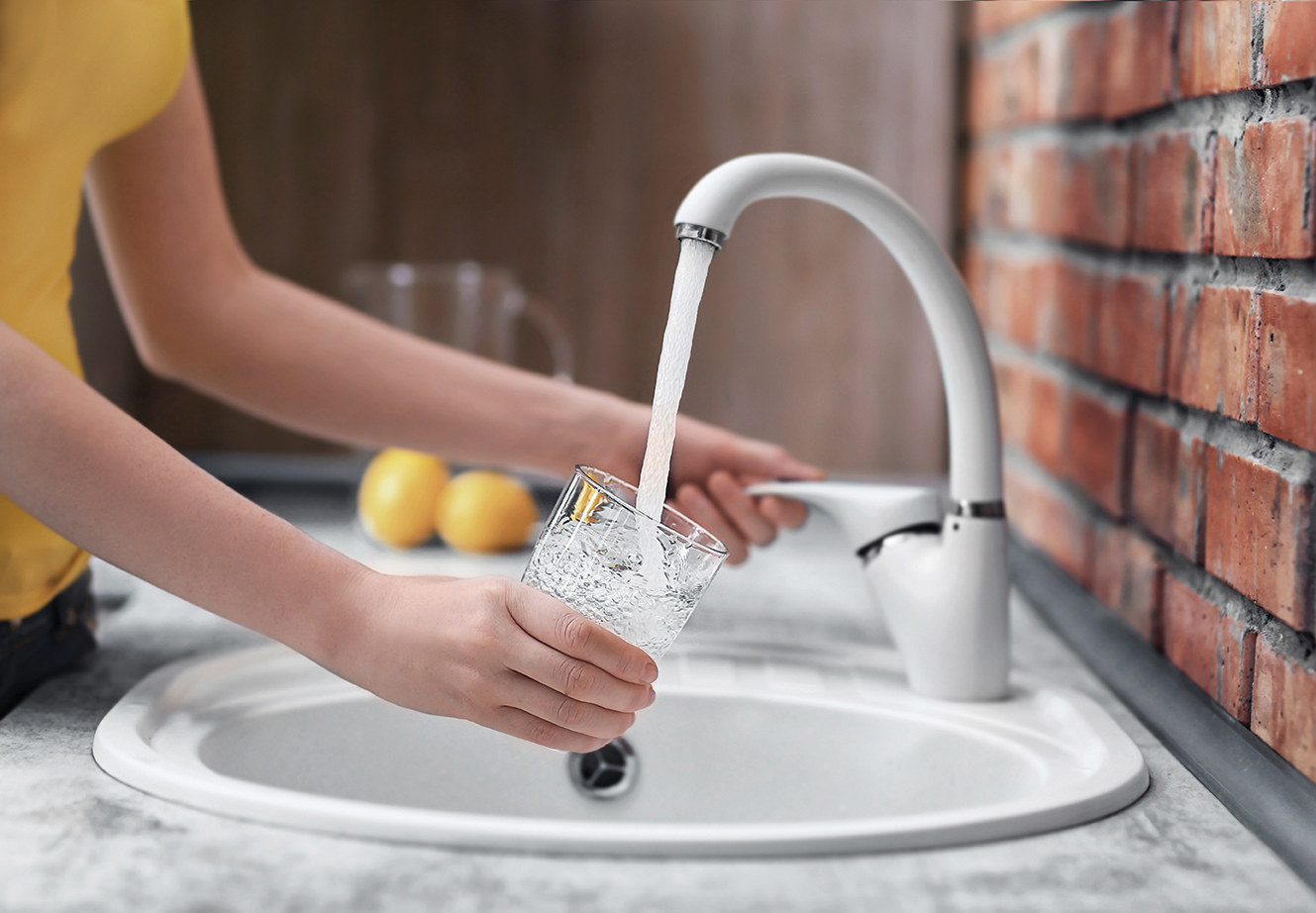Filling glass with water from a sink