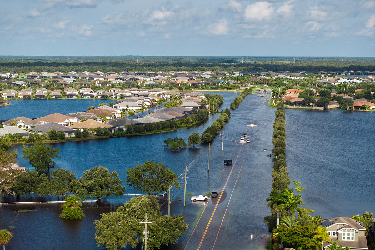 Flooded Florida street with stuck car after hurricane Debby rainfall surrounded with water. Consequences of natural disaster