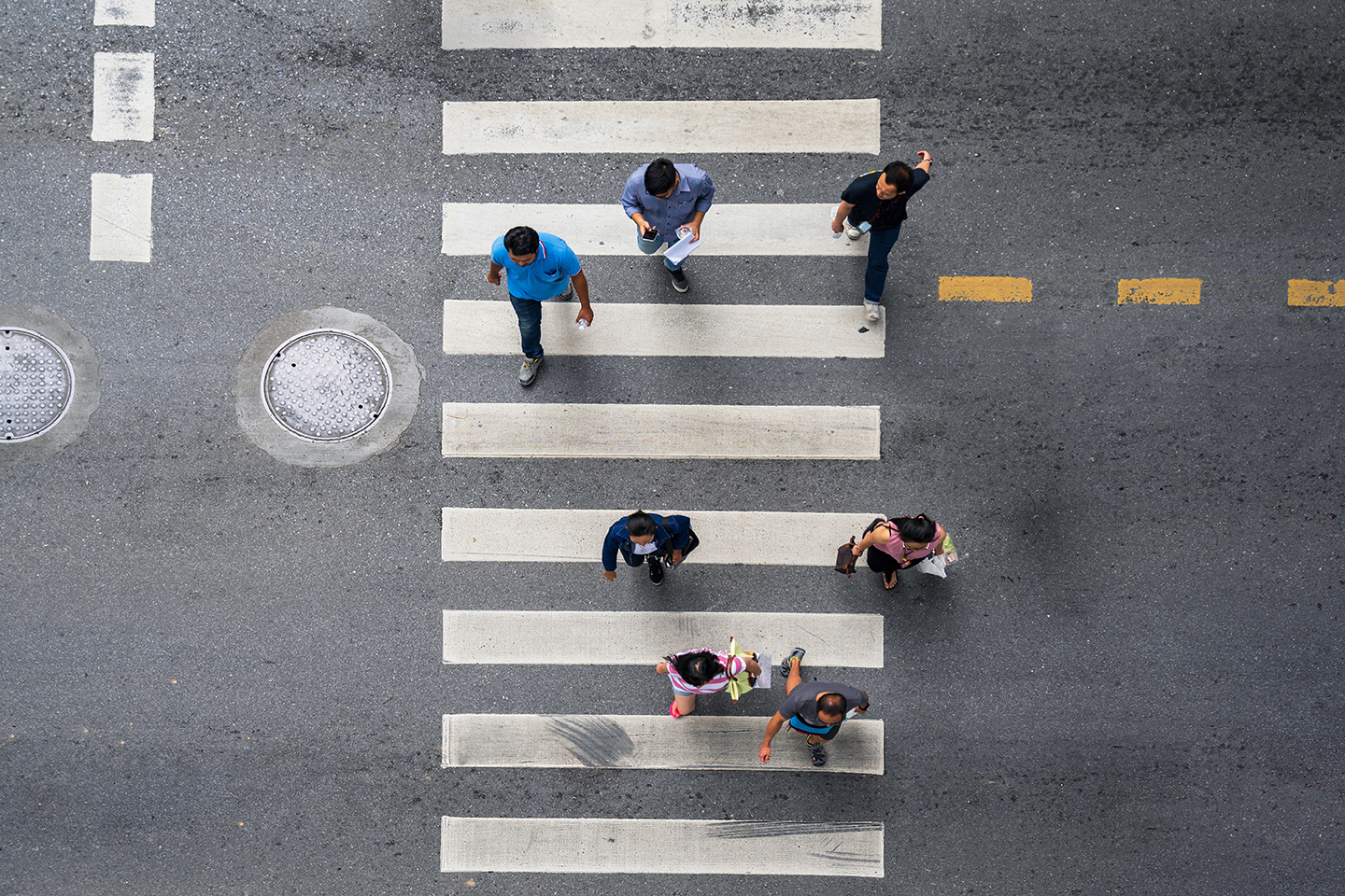 photo of people walking across the street