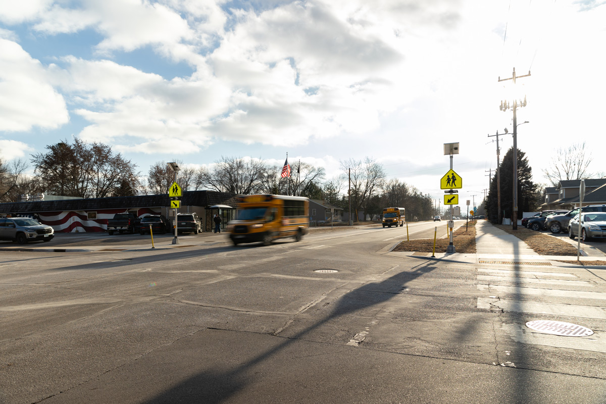 School bus on a road with a cross walk