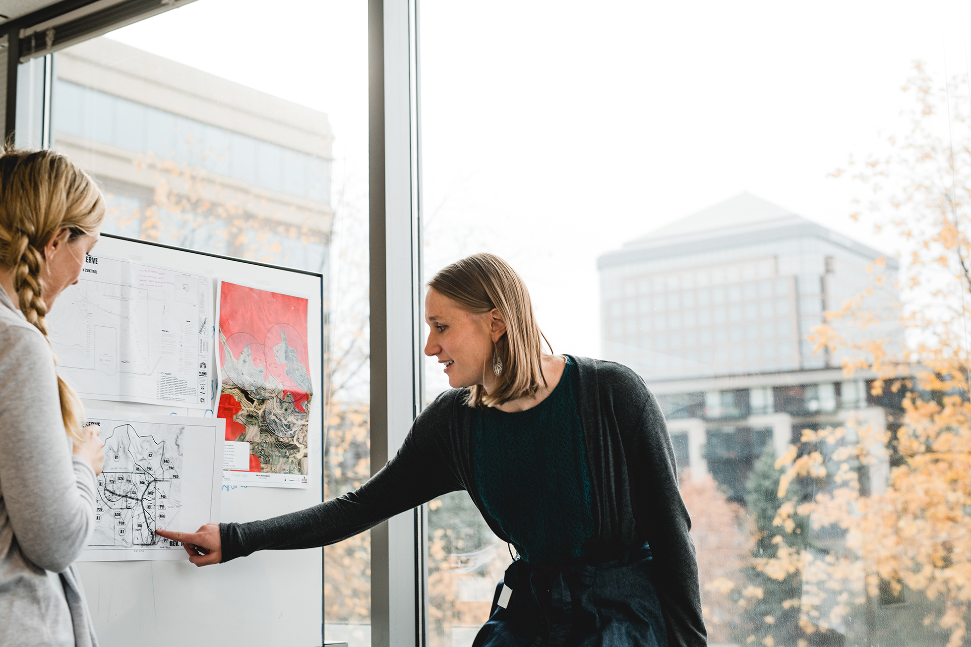 people looking at whiteboard planning