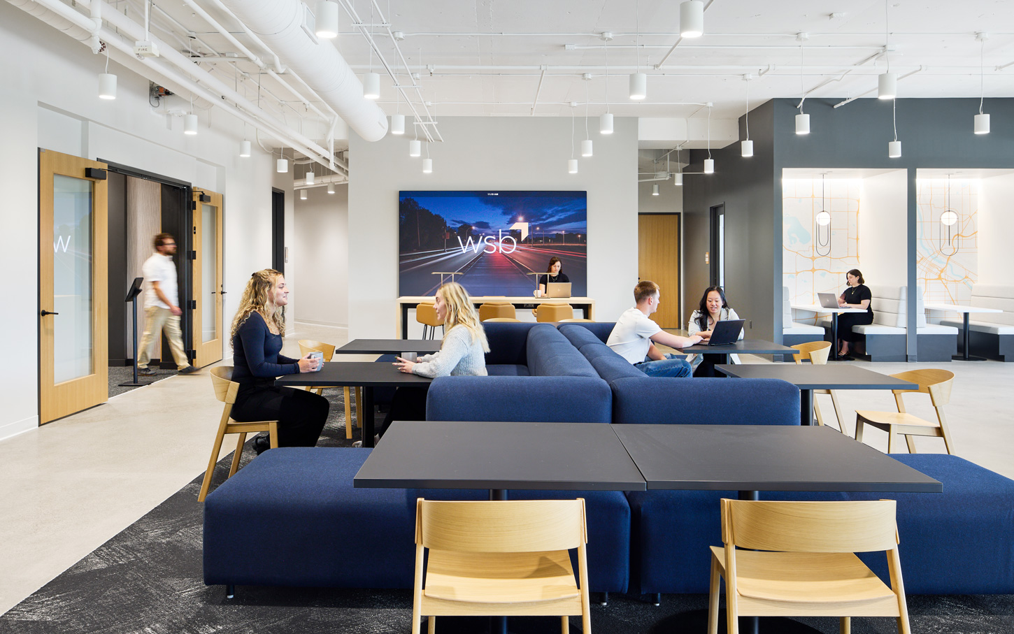 WSB Staff working in the lobby of wsb headquarters in golden valley, mn