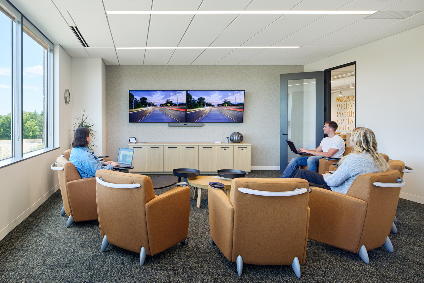 WSB Staff working in a conference room with chairs and a tv.