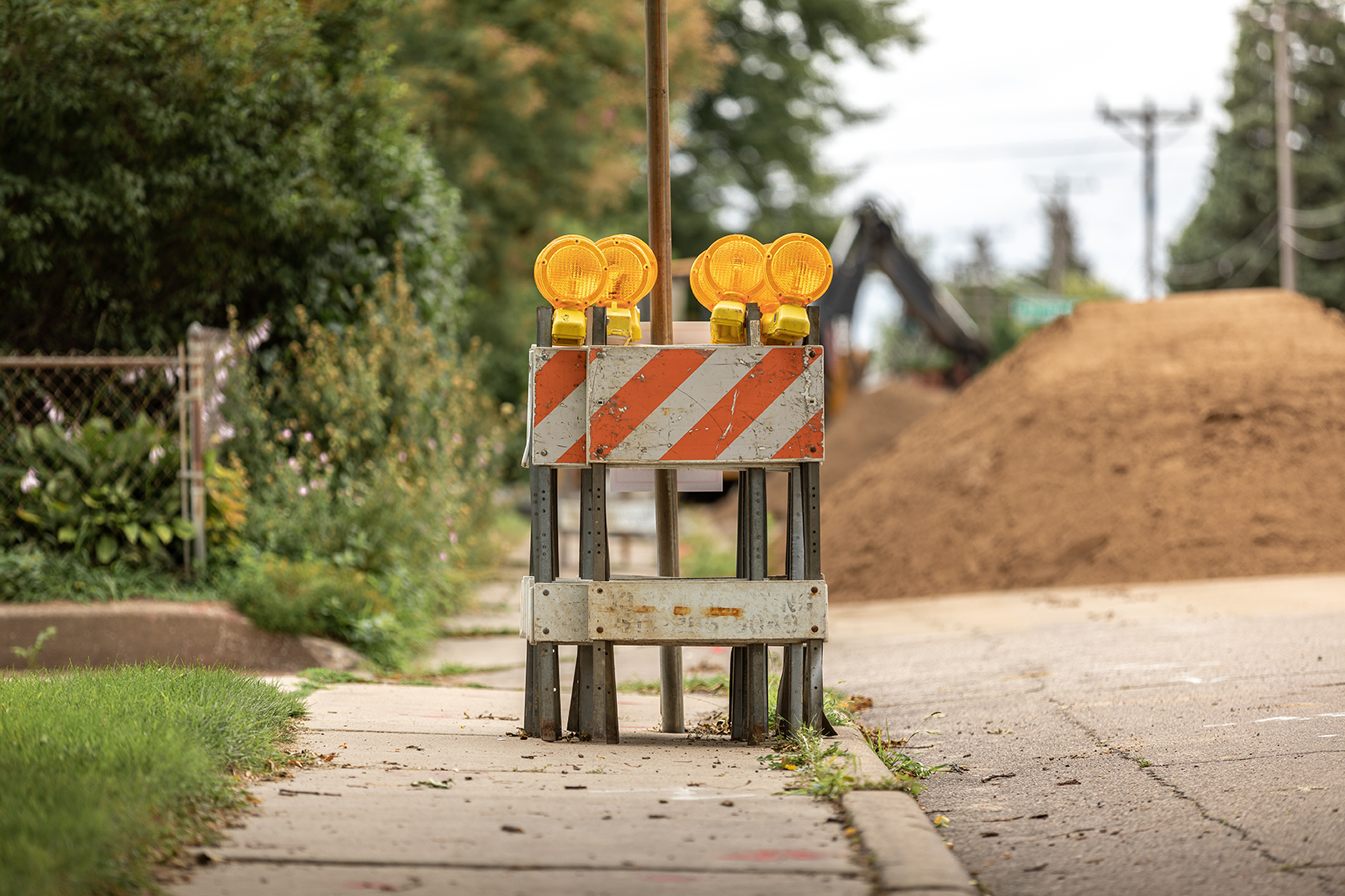 signs on the street with dirt behind