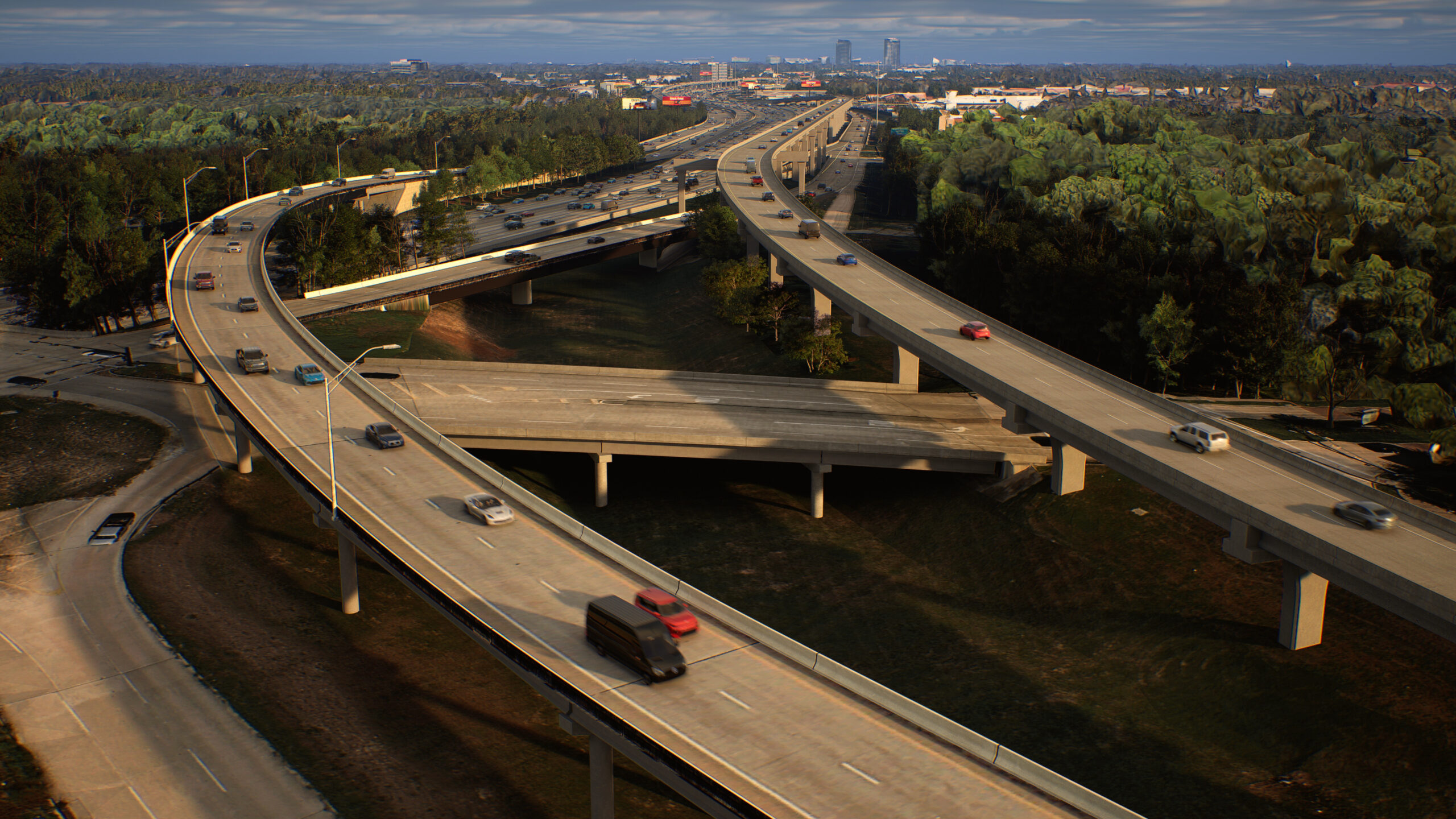 Aerial view of a large highway interchange with multiple elevated ramps curving through a wooded area. Several vehicles travel on the roads, and the city skyline is visible in the distance.