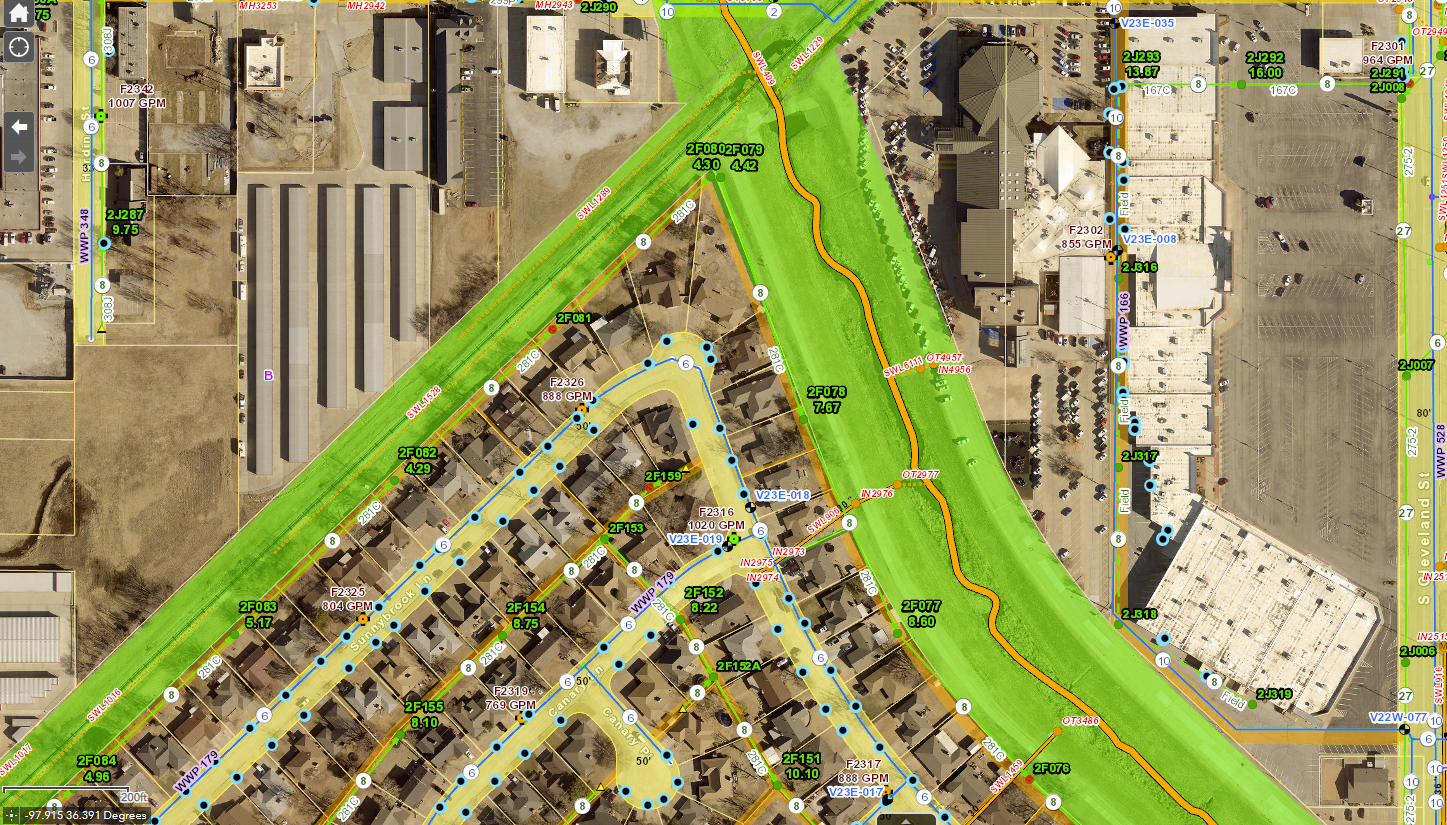 Aerial GIS map of a neighborhood in Enid, Oklahoma showing streets, property parcels, utility lines, and a green highlighted floodplain corridor.