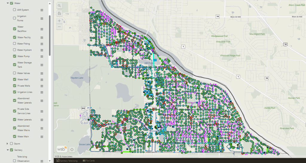 GIS map showing a municipal water system with color‑coded points and lines representing water mains, valves, hydrants, meters, and related infrastructure across a defined service area.