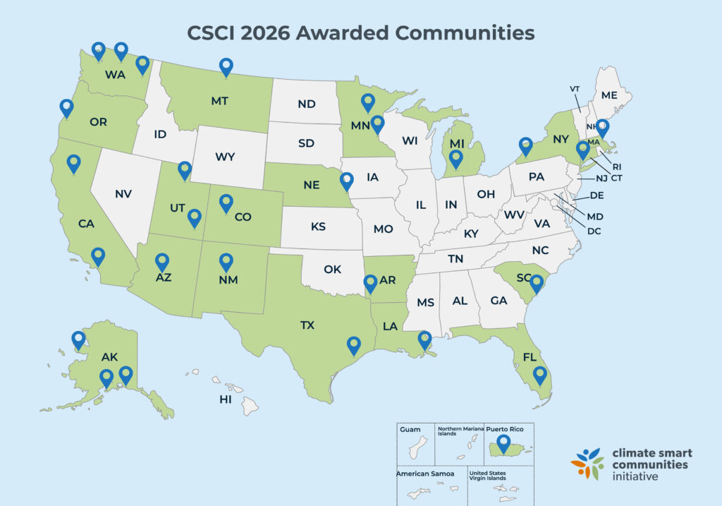 Map titled "CSCI 2026 Awarded Communities" showing Climate Smart Communities Initiative award recipients across the United States. Awarded states are highlighted in green with location markers placed throughout Alaska, Washington, Oregon, California, Arizona, Utah, Colorado, New Mexico, Texas, Louisiana, Arkansas, Nebraska, Minnesota, Michigan, New York, Massachusetts, South Carolina, Florida, Montana and Puerto Rico. The Climate Smart Communities Initiative logo appears in the lower-right corner.