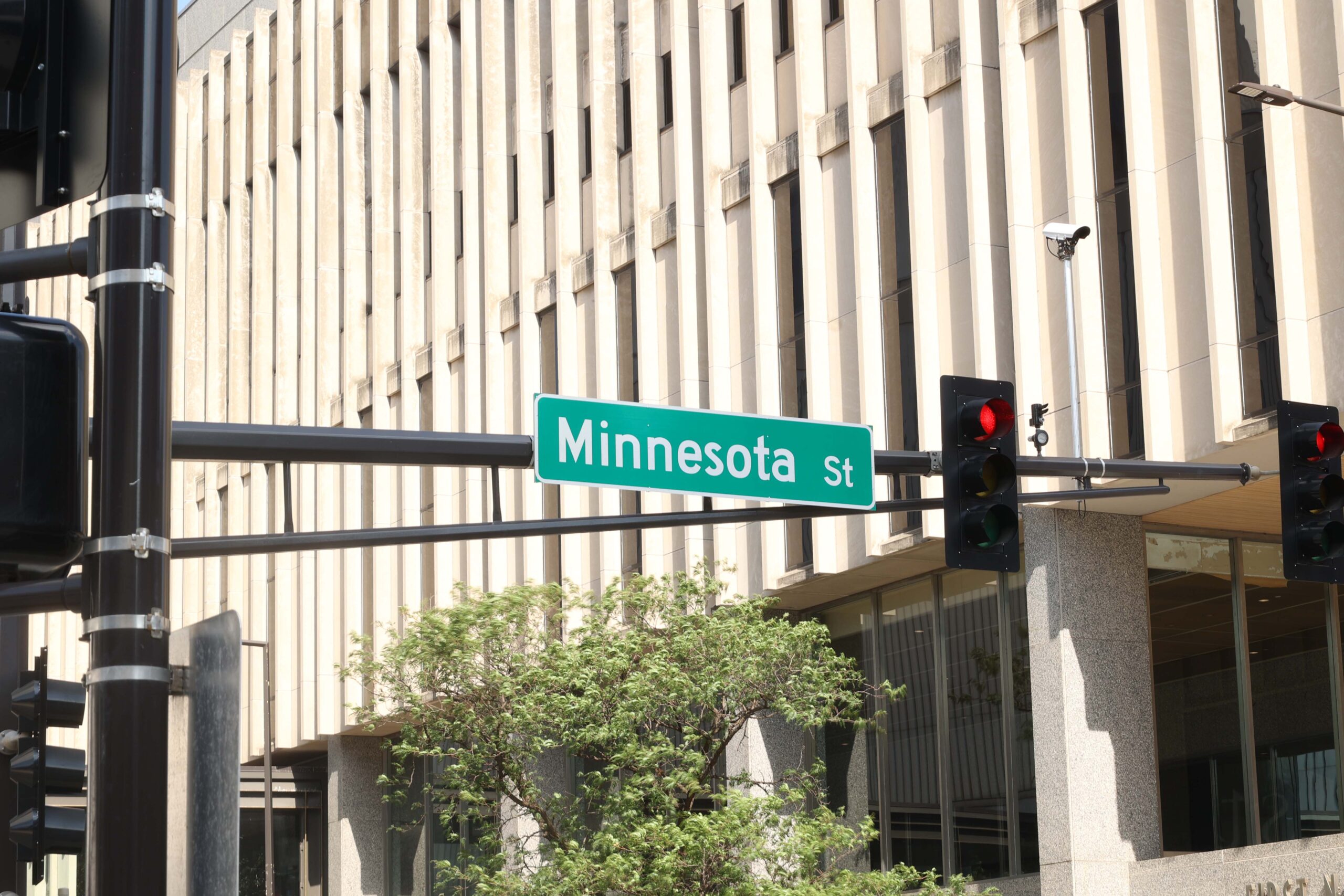 Traffic signals and a Street sign at a downtown intersection.